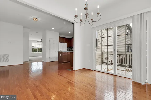 a view of a room with wooden floor and windows