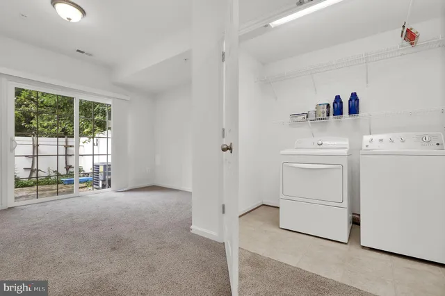 a view of storage and utility room with washer and dryer