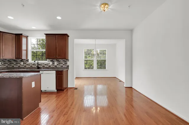 a view of kitchen with wooden floor and electronic appliances