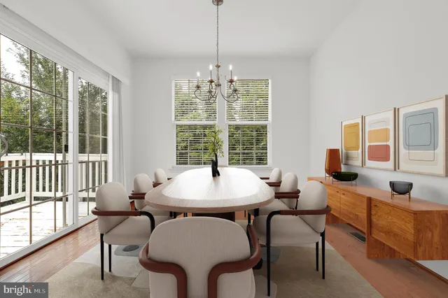 a dining room with furniture a chandelier and wooden floor