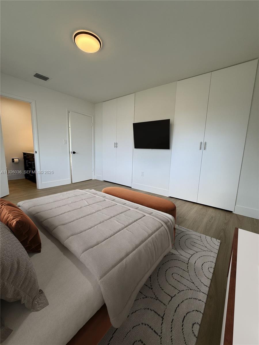 4850 Southwest 93rd Court Miami, FL 33165 - Photo 15 of 25 a bedroom with a bed and a flat screen tv
