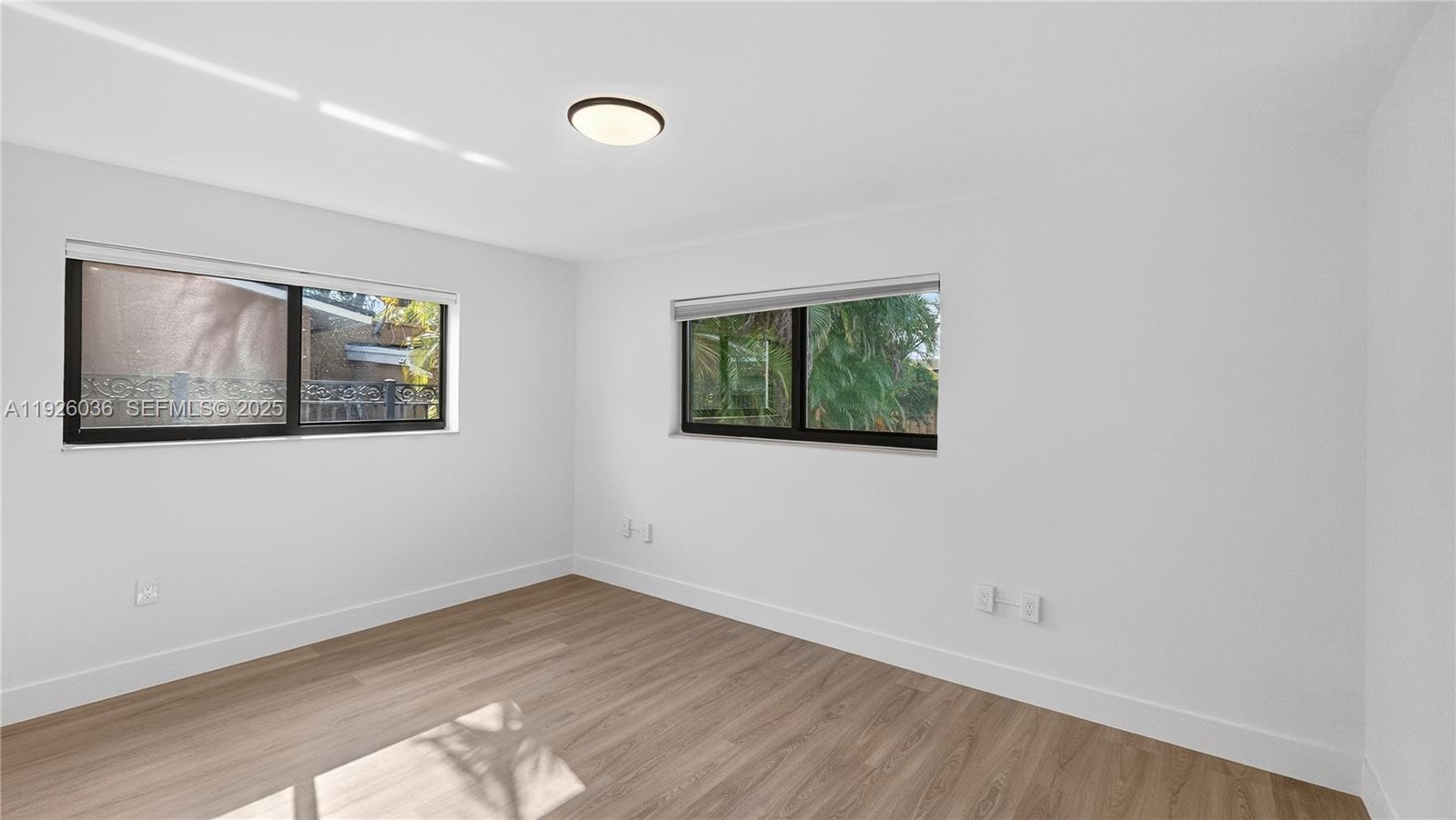 4850 Southwest 93rd Court Miami, FL 33165 - Photo 17 of 25 an empty room with wooden floor and window