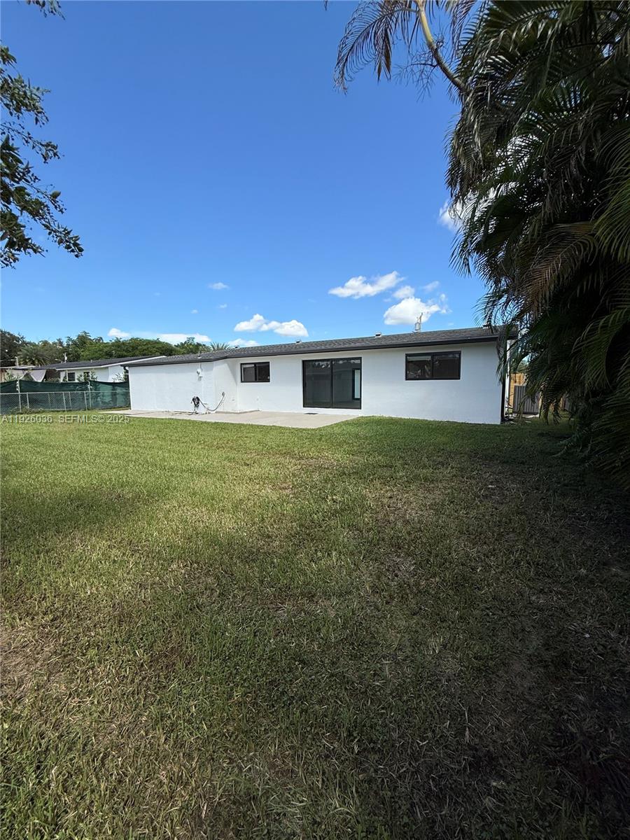 4850 Southwest 93rd Court Miami, FL 33165 - Photo 25 of 25 a view of a house with a yard and a large tree