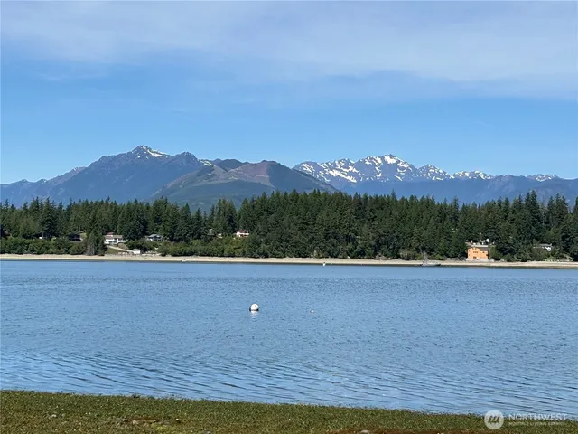 a view of a house with a yard and mountain view
