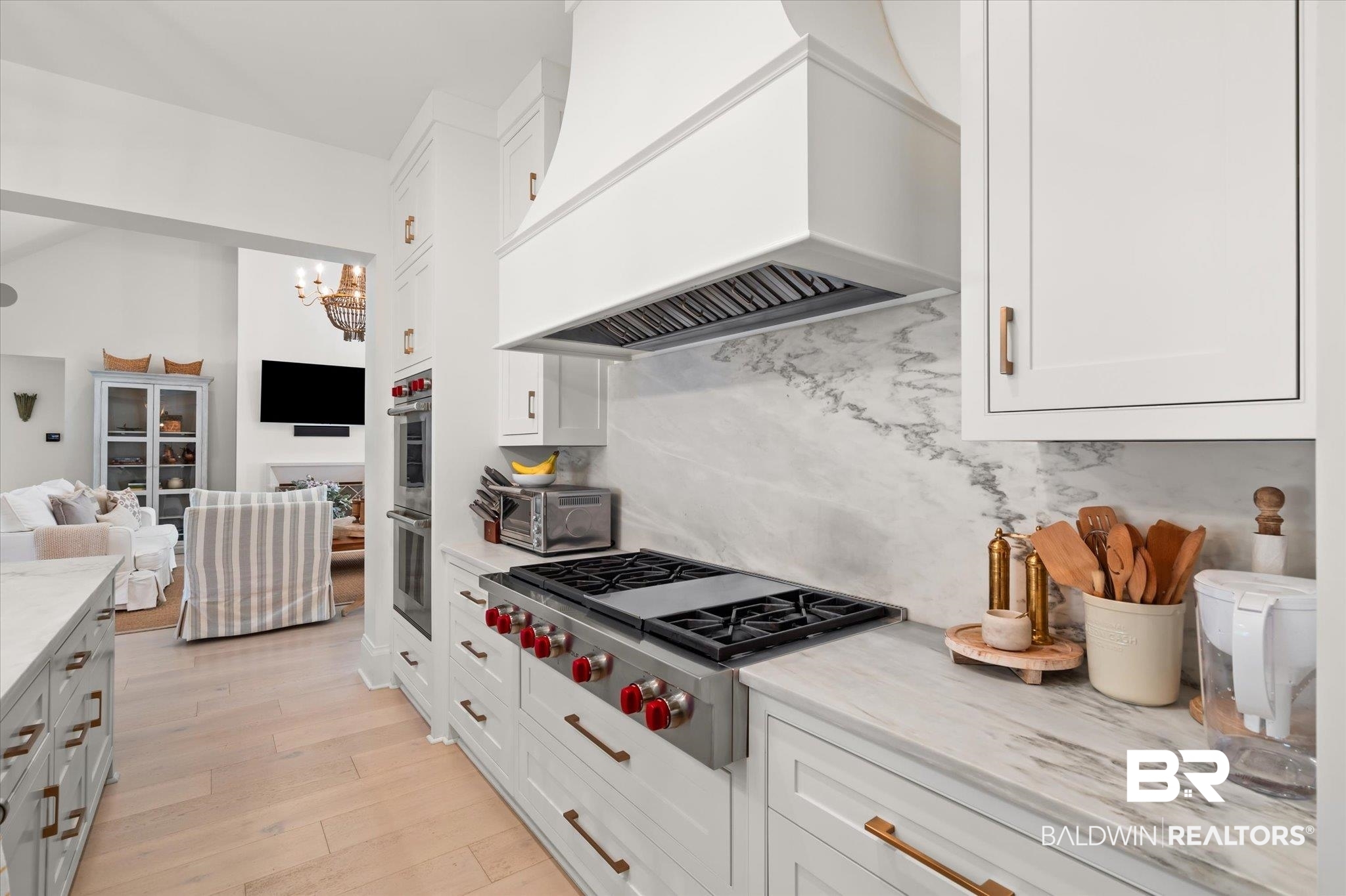 2 Garden Trace Mobile, AL 36608 - Photo 6 of 55 Kitchen with white cabinetry, backsplash, custom exhaust hood, stainless steel appliances, and light wood-type flooring