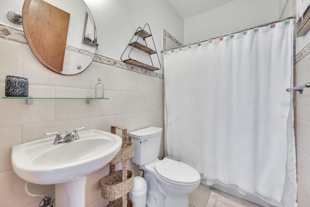 413 Camino Carretas, Unit A7 Rincon, Rincón 00677 - Photo 17 of 23 a bathroom with a sink a toilet and a mirror
