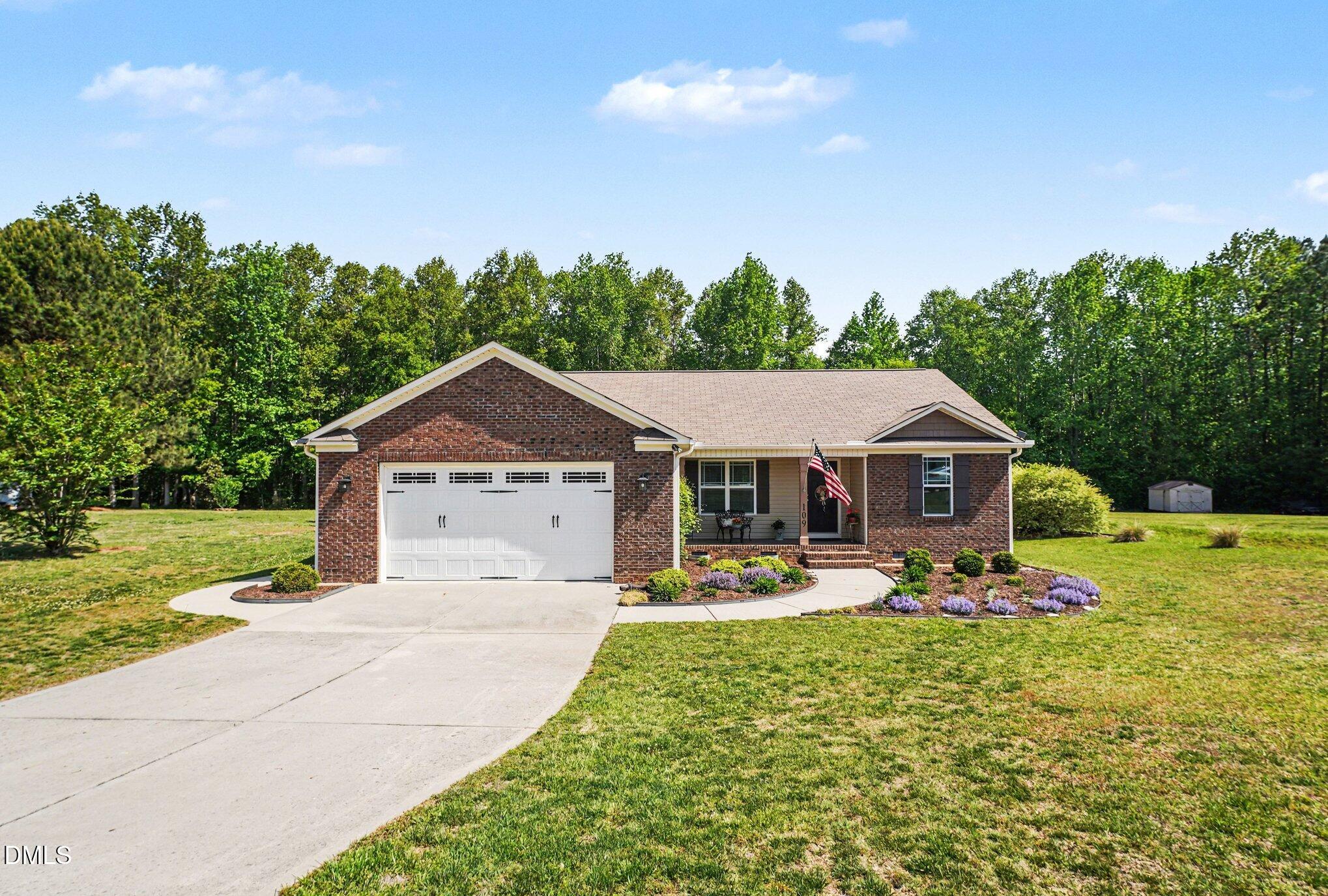 109 His Way Middlesex, NC 27557 - Photo 2 of 21 a view of a house with a yard patio and fire pit