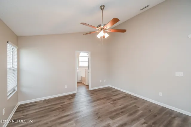 a bathroom with a tub a sink and a large mirror