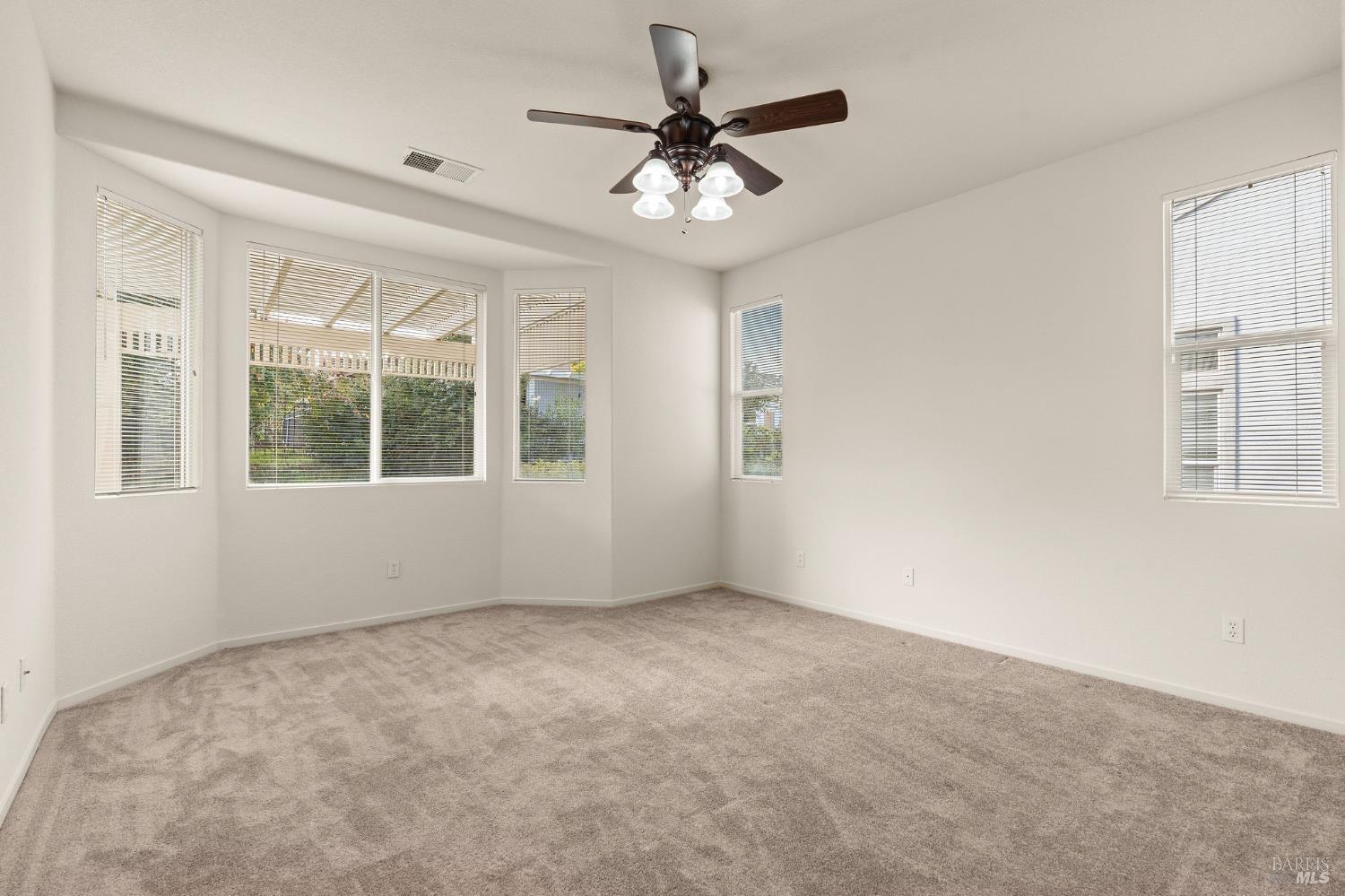 732 Summerset Drive Rio Vista, CA 94571 - Photo 17 of 68 primary bedroom with bay window and ceiling fan