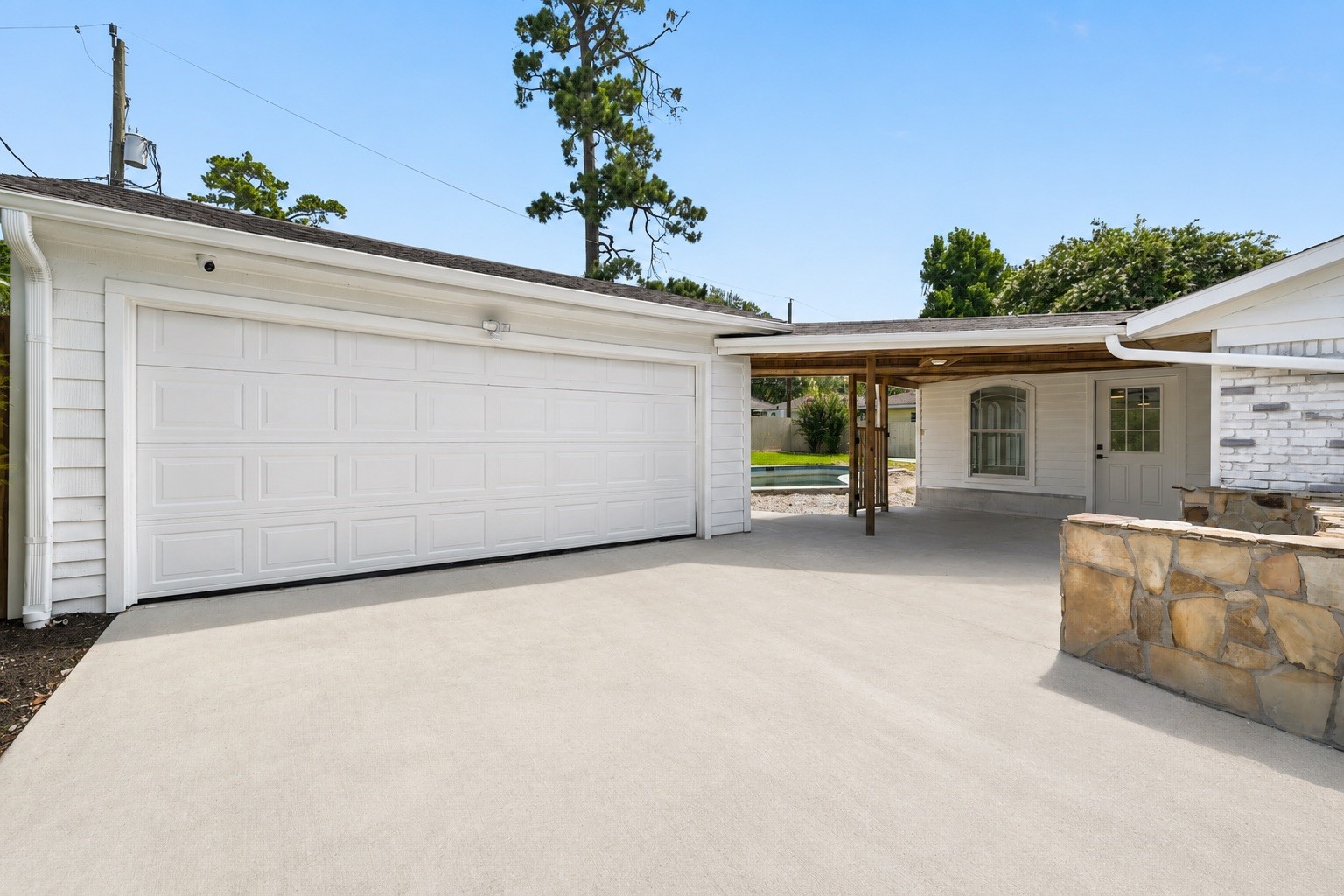 18918 Casper Drive Spring, TX 77373 - Photo 27 of 32 The detached garage features a brand new garage door and additional space for storage or workshop needs. This photo has been virtually staged.