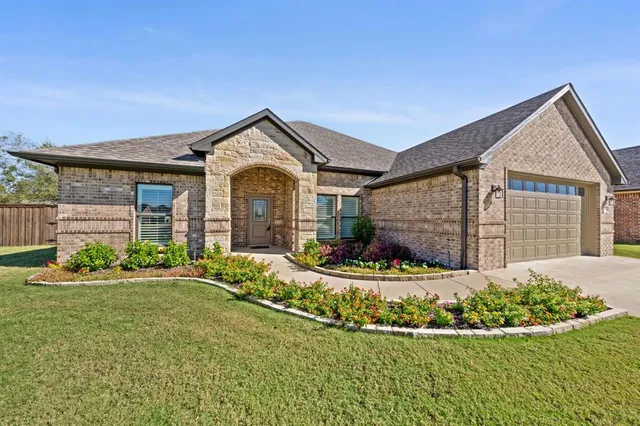 a front view of a house with a yard