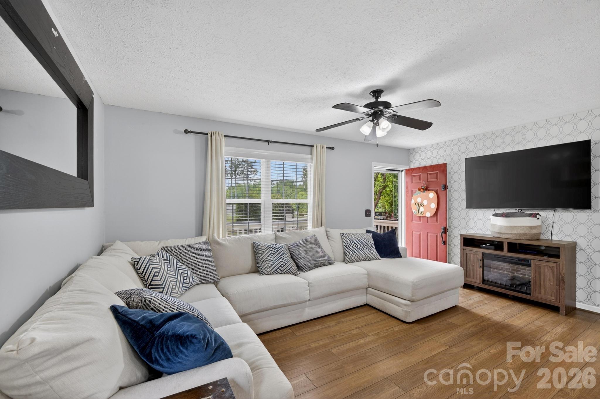 2308 Walt Arney Road Lenoir, NC 28645 - Photo 27 of 37 a living room with furniture and a flat screen tv