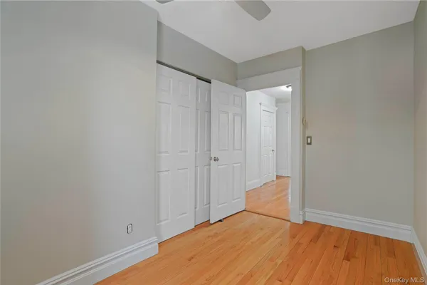 a view of a room with wooden floor and brick wall