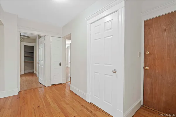 a view of a hallway with wooden floor