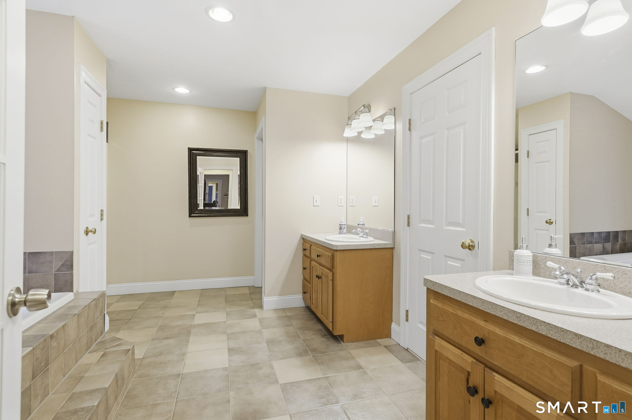 24 Scott Road Oxford, CT 06478 - Photo 14 of 39 a bathroom with a sink a vanity a mirror and a bathtub