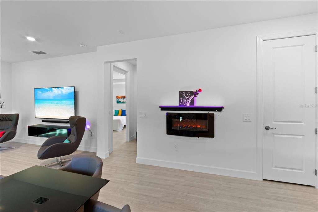 6713 Alstead Circle Lakewood Ranch, FL 34202 - Photo 13 of 86 a living room with furniture and a flat screen tv