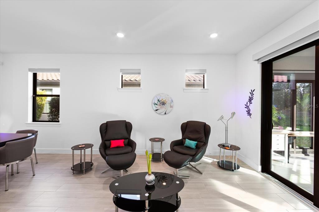 6713 Alstead Circle Lakewood Ranch, FL 34202 - Photo 16 of 86 a living room with furniture and a wooden floor
