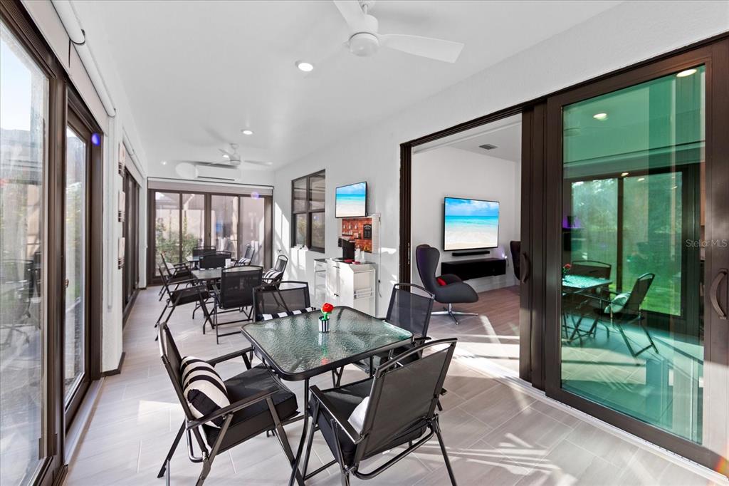 6713 Alstead Circle Lakewood Ranch, FL 34202 - Photo 18 of 86 a dining room with furniture wooden floor and garden view