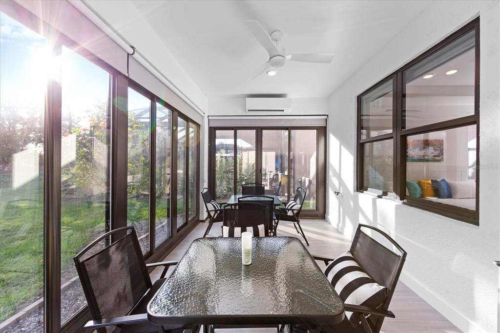 6713 Alstead Circle Lakewood Ranch, FL 34202 - Photo 21 of 86 a dining room with furniture large windows and wooden floor