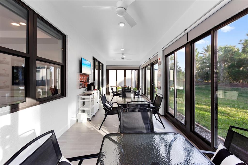 6713 Alstead Circle Lakewood Ranch, FL 34202 - Photo 23 of 86 a view of a dining room with furniture large windows and wooden floor