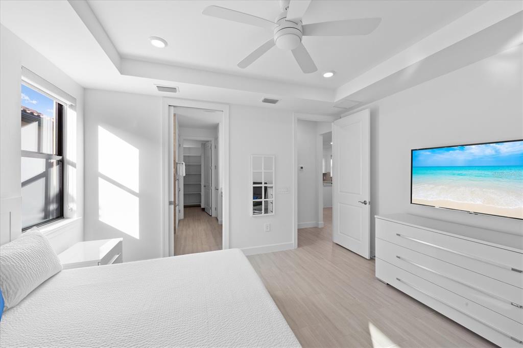 6713 Alstead Circle Lakewood Ranch, FL 34202 - Photo 25 of 86 a view of a bedroom with wooden floor and a ceiling fan