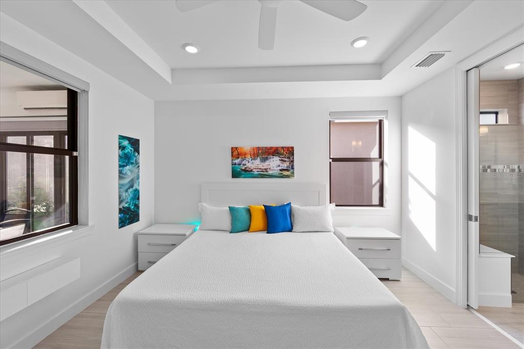 6713 Alstead Circle Lakewood Ranch, FL 34202 - Photo 27 of 86 a bedroom with a large bed and a large mirror