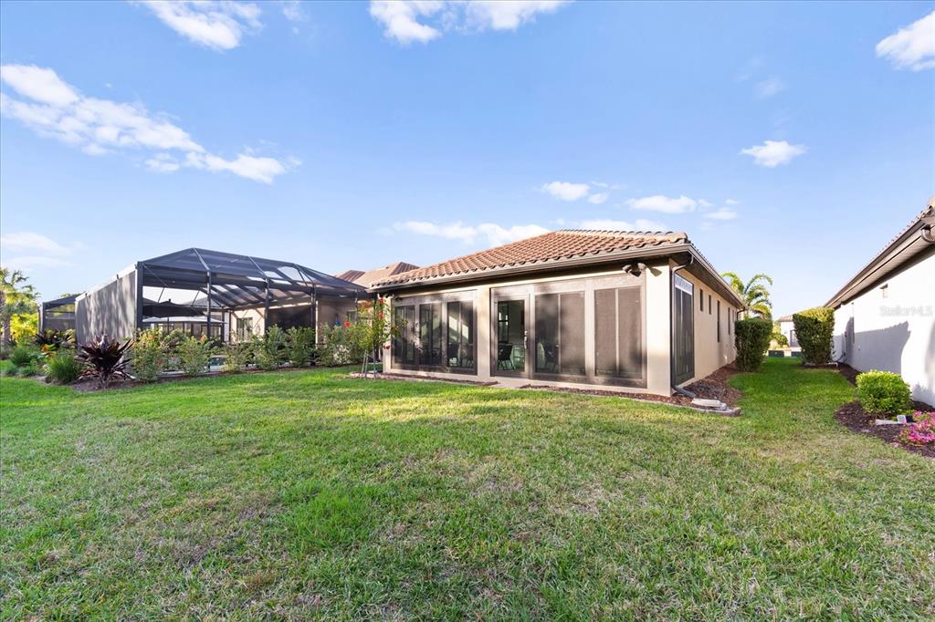 6713 Alstead Circle Lakewood Ranch, FL 34202 - Photo 37 of 86 a view of a house with backyard and garden