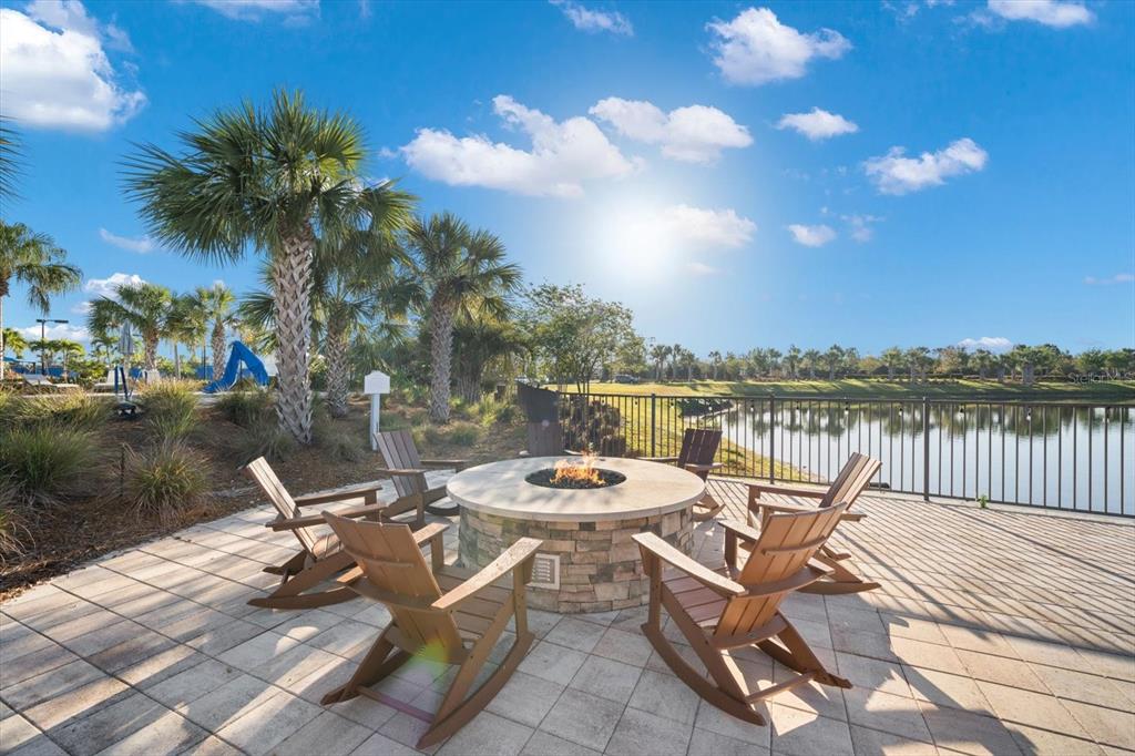 6713 Alstead Circle Lakewood Ranch, FL 34202 - Photo 74 of 86 a view of a lake with couches chairs and wooden floor