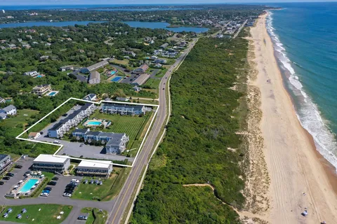 an aerial view of residential houses with outdoor space