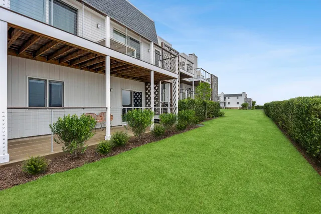 a view of a house with a yard and plants