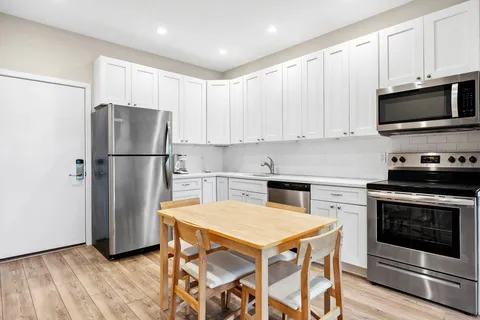 a kitchen with a refrigerator stove and microwave