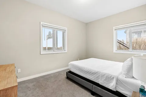 a bedroom with a bed and window