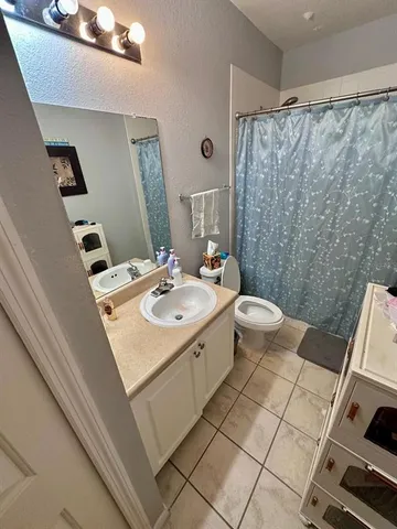 a bed room with furniture and a chair