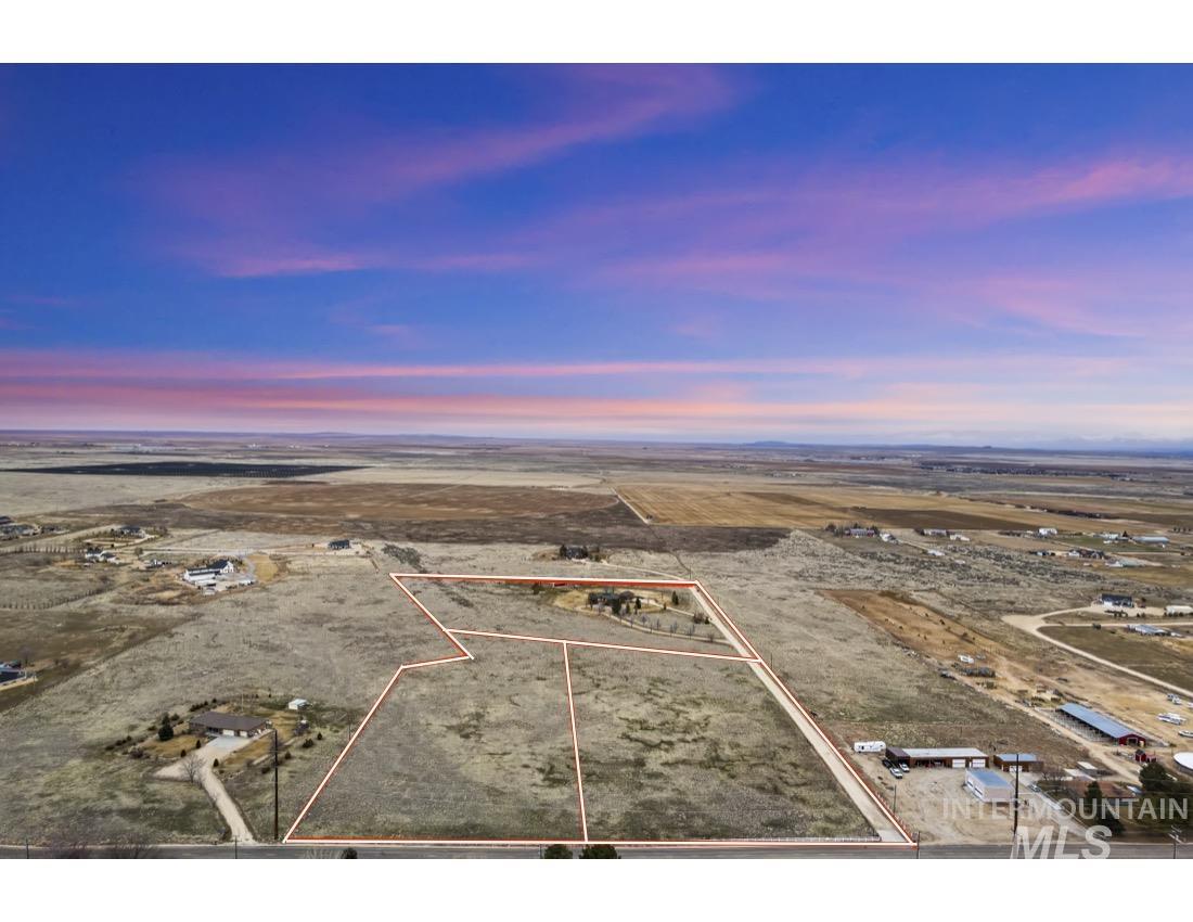 9661 West Kuna Road Kuna, ID 83634 - Photo 2 of 4 Aerial view at dusk of property boundaries highlighted, a view of countryside, and view of desert landscape