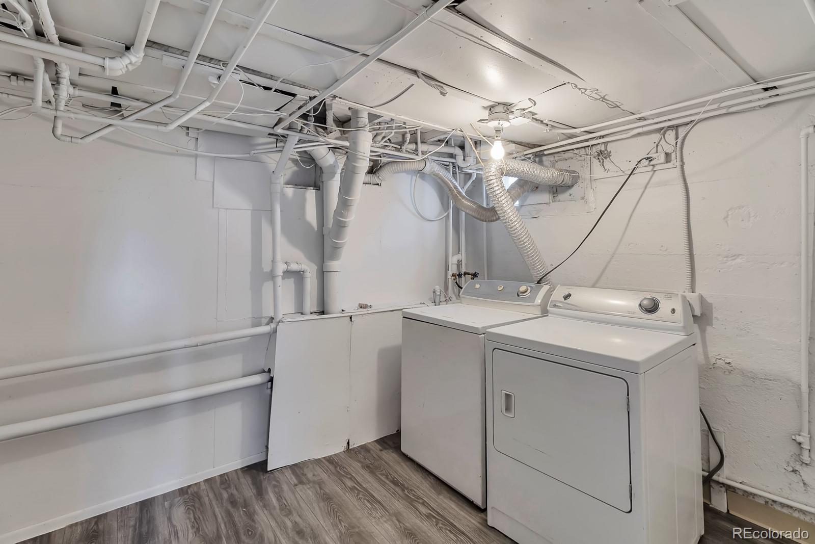 504 South Raleigh Street Denver, CO 80219 - Photo 17 of 25 a utility room with cabinets and washer