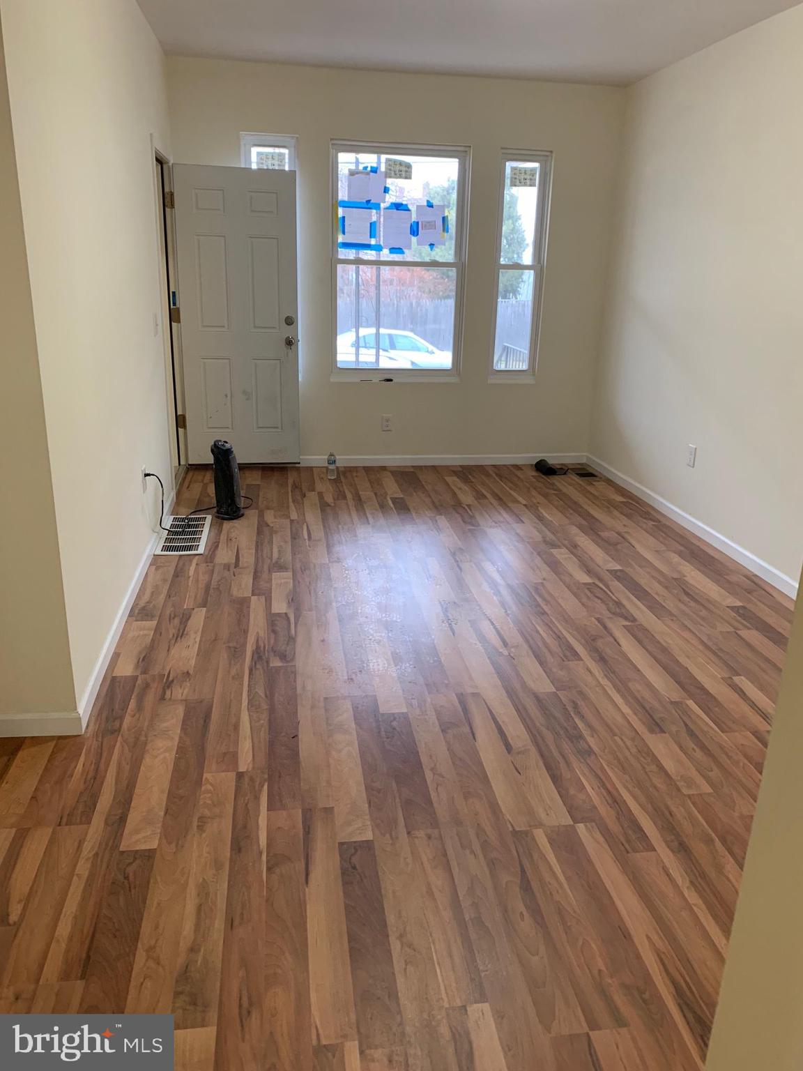 4840 North Camac Street, Unit 1 Philadelphia, PA 19141 - Photo 4 of 8 an empty room with wooden floor and windows