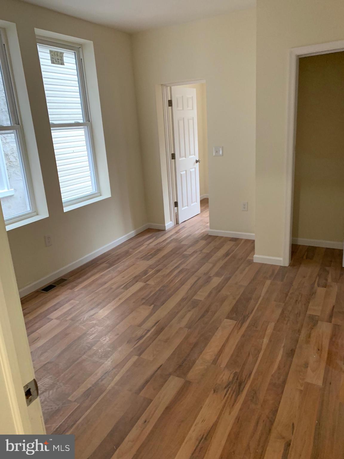 4840 North Camac Street, Unit 1 Philadelphia, PA 19141 - Photo 5 of 8 a view of an empty room with wooden floor and a window