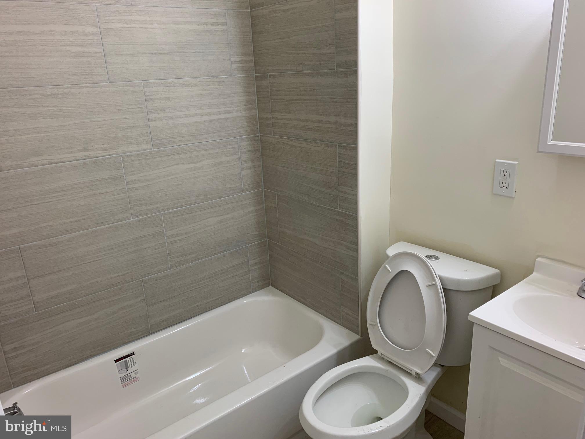 4840 North Camac Street, Unit 1 Philadelphia, PA 19141 - Photo 8 of 8 a bathroom with a sink a toilet and bathtub