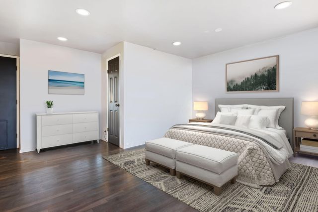 a spacious bedroom with a bed and a couch