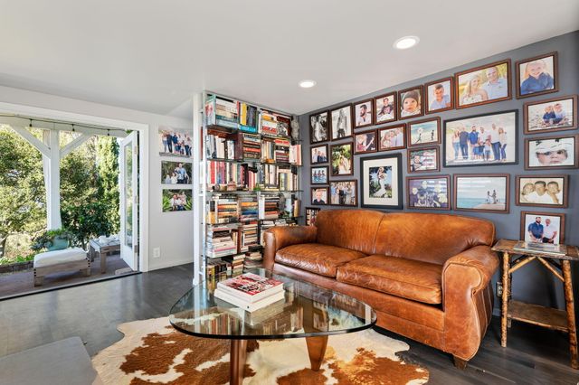 a living room with furniture and a book shelf