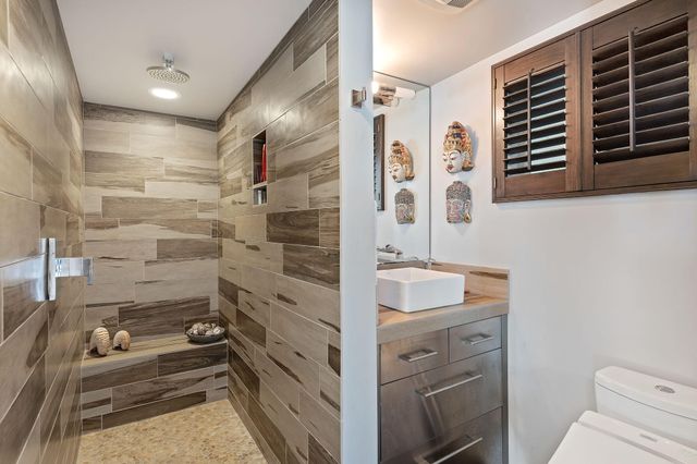 a bathroom with a sink toilet and shower