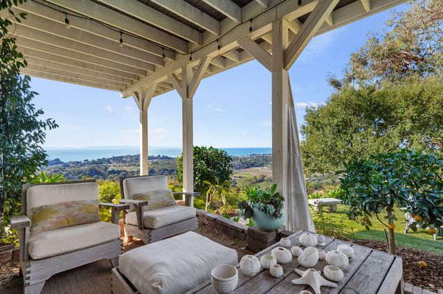 a view of a field with large trees