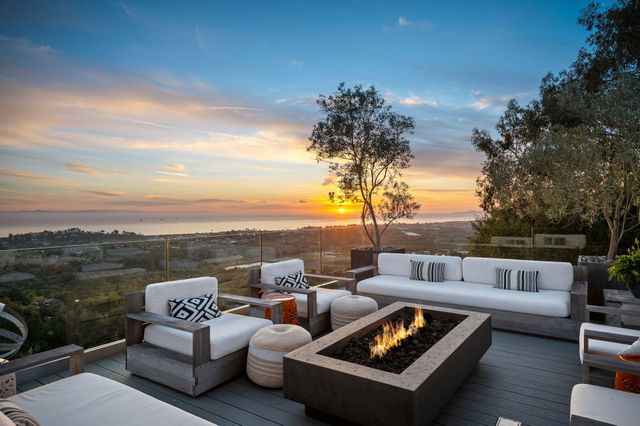 a terrace of a house with couches and city view