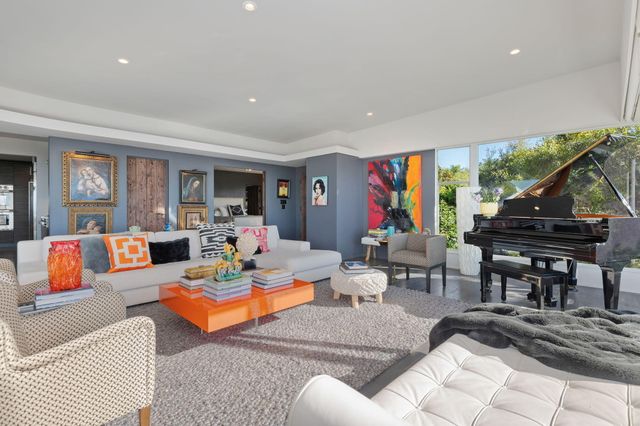 a living room with furniture a rug and a large window