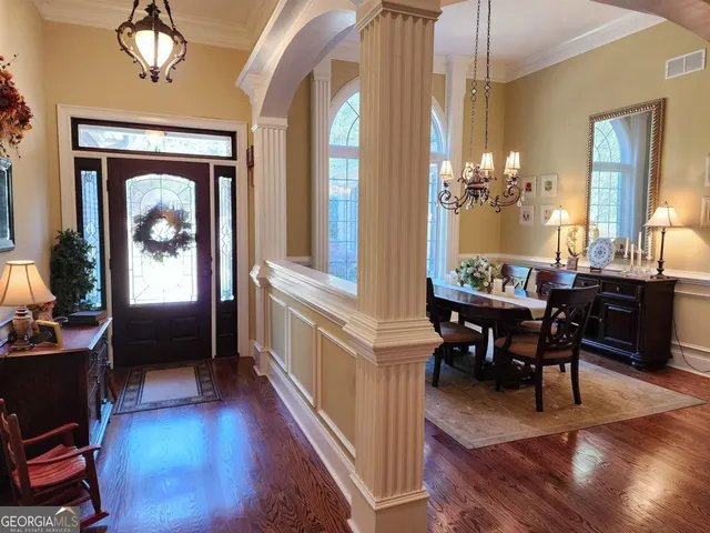 a view of a dining room with furniture window and wooden floor