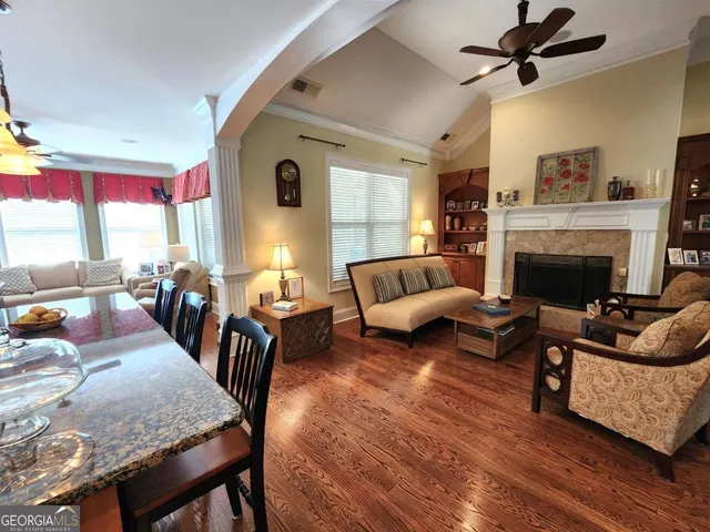 a living room with furniture fireplace and a table
