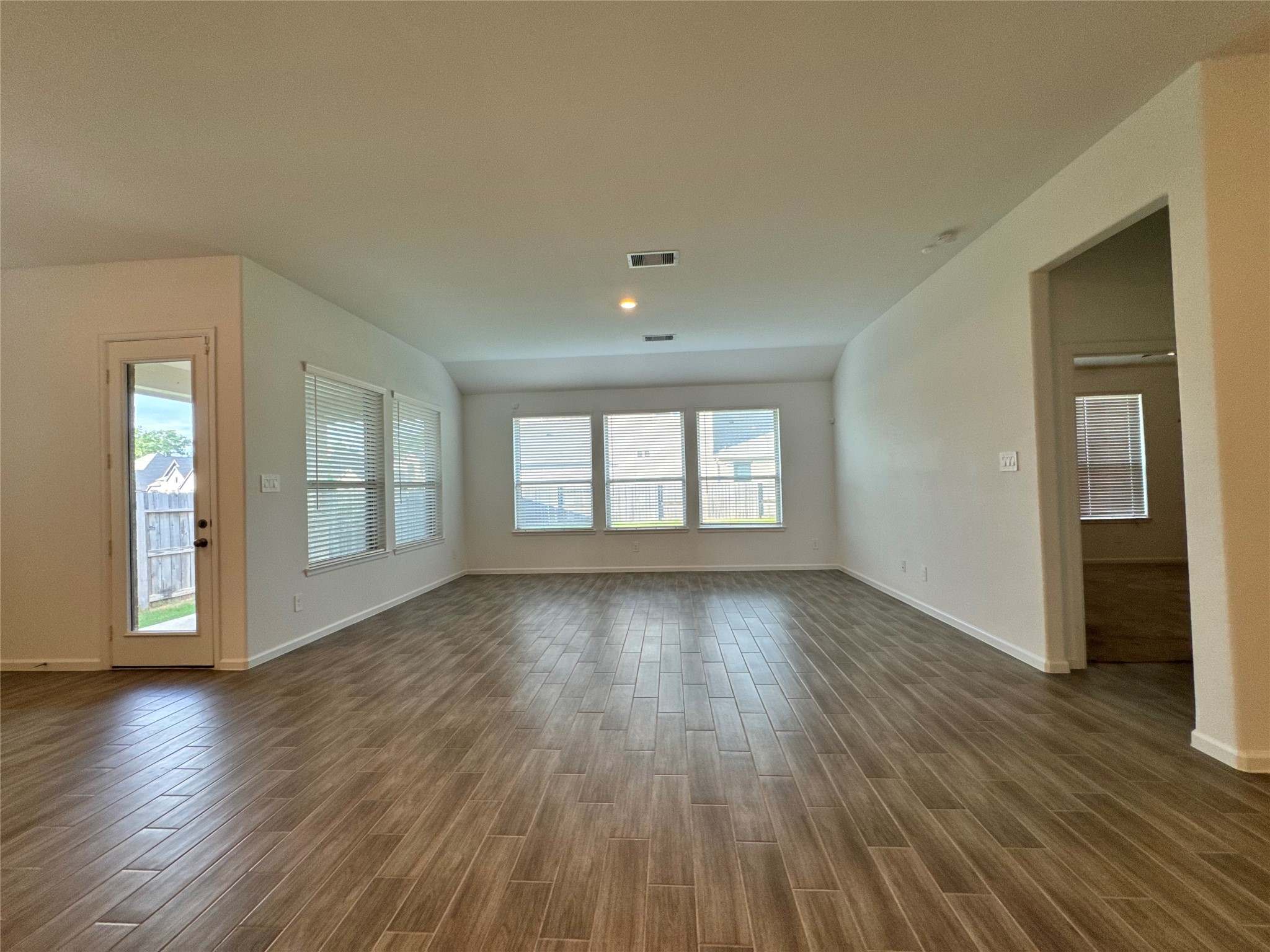 17311 Grand Canyon Road Conroe, TX 77302 - Photo 12 of 28 a view of an empty room with window and wooden floor