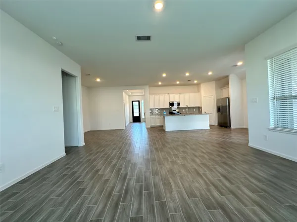an empty room with closet and fan