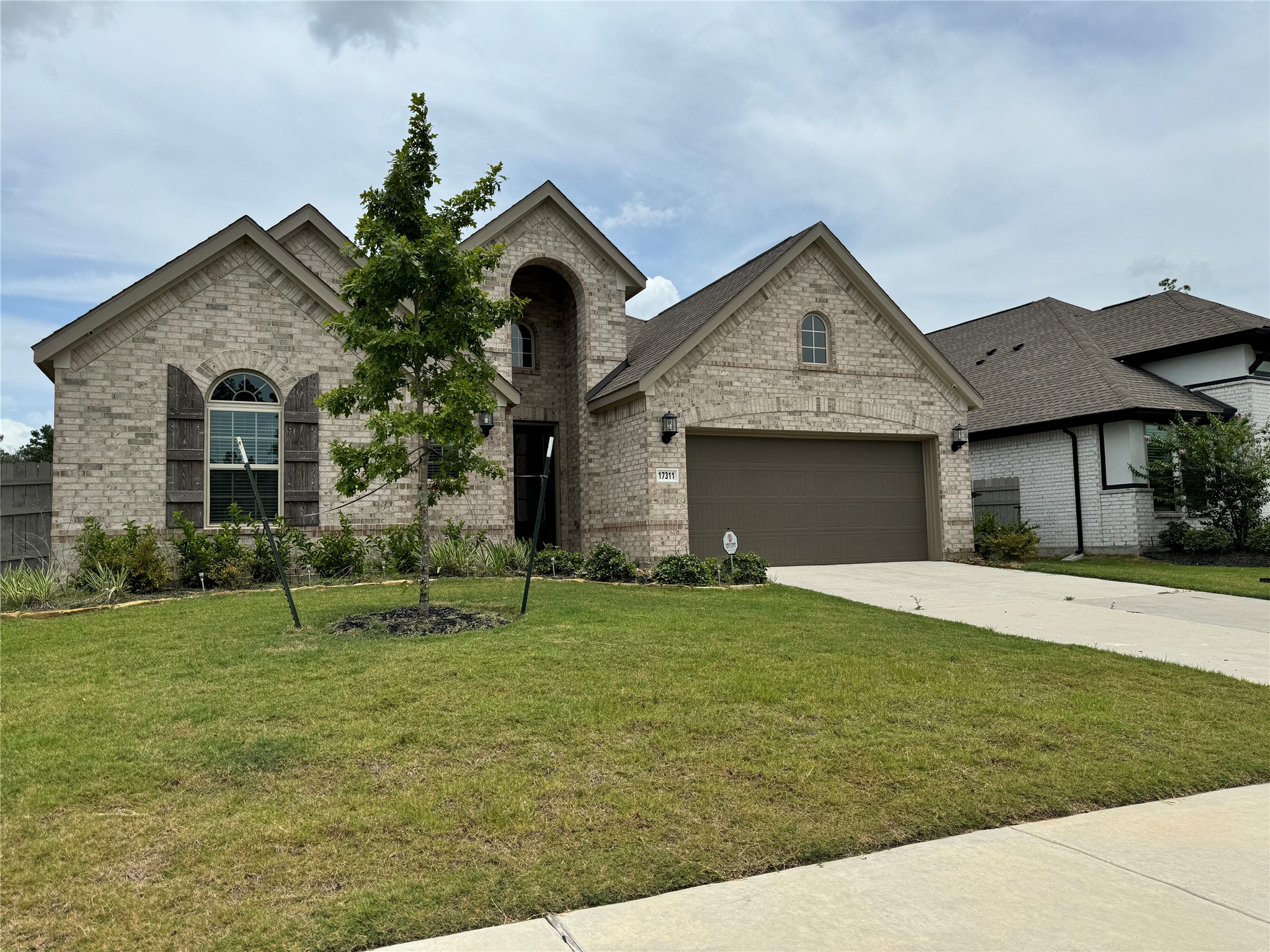 17311 Grand Canyon Road Conroe, TX 77302 - Photo 2 of 28 a front view of a house with a yard and garage