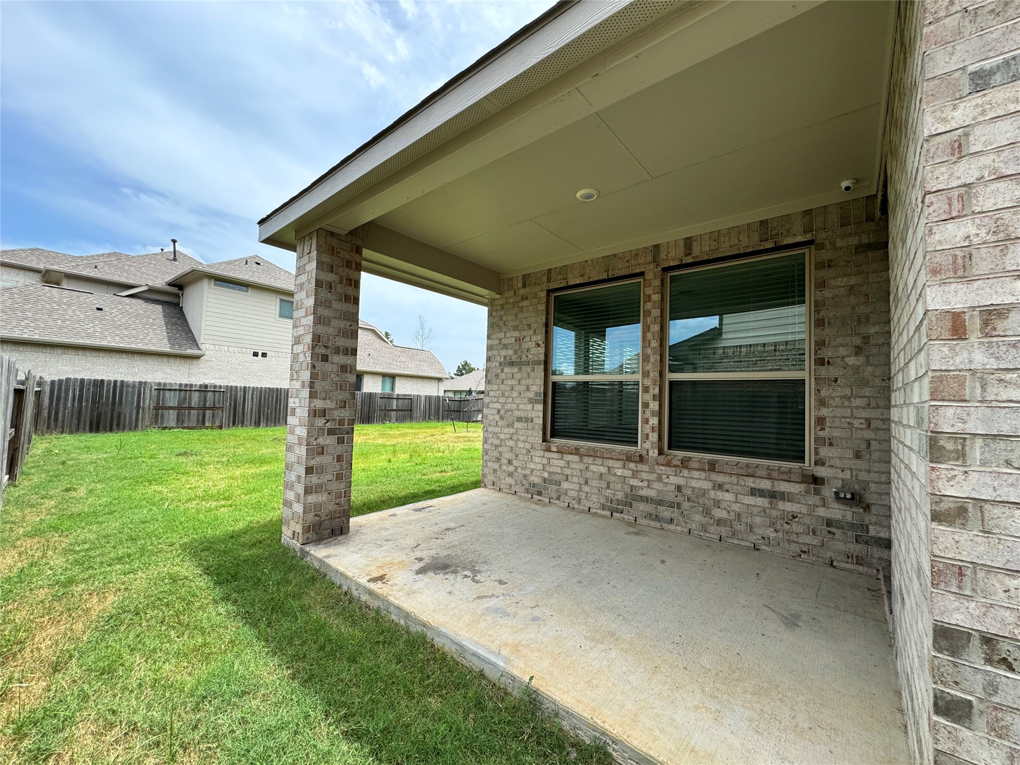 17311 Grand Canyon Road Conroe, TX 77302 - Photo 26 of 28 a view of a house with a yard and garage